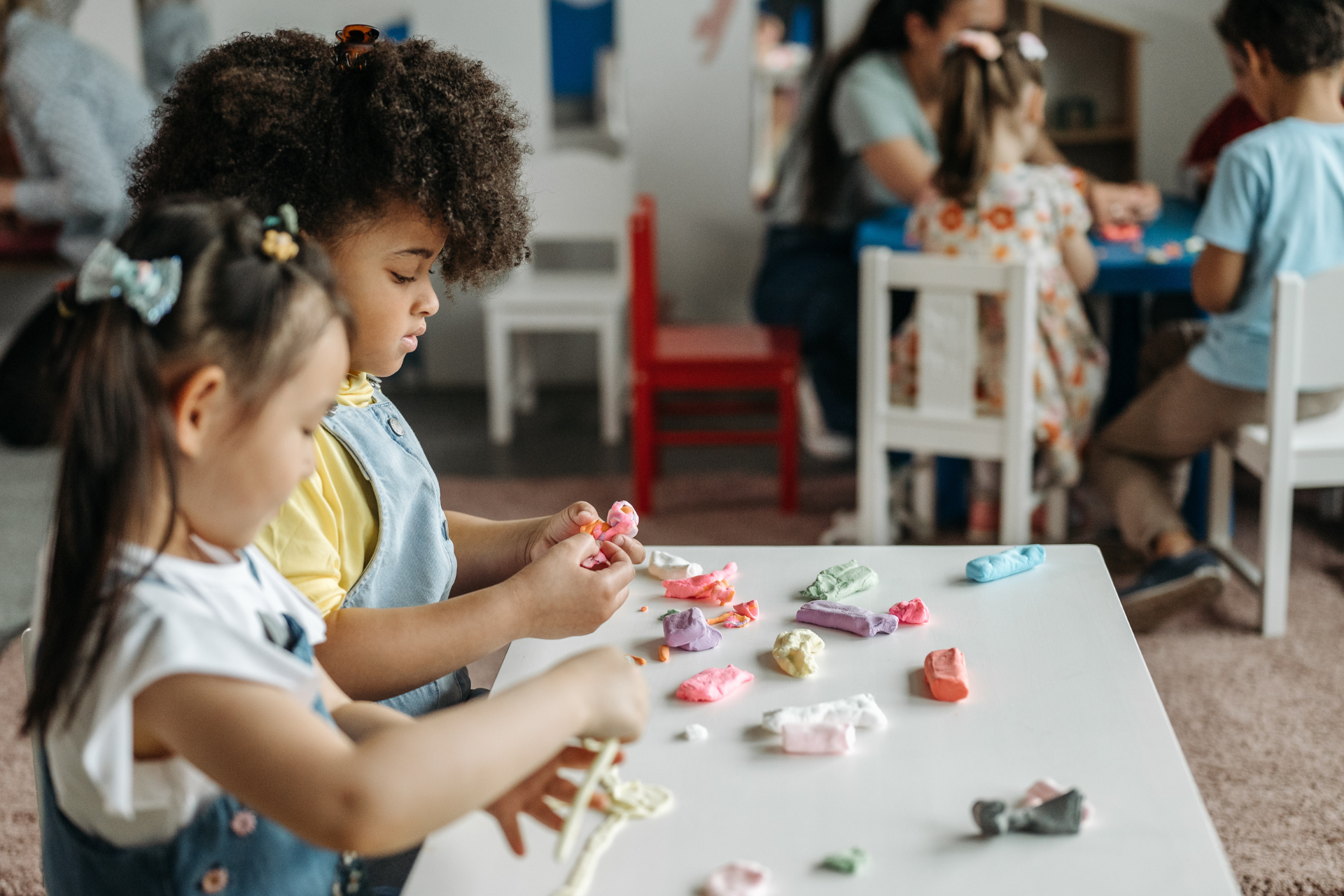 Kids aged 2-3 playing with play-doh