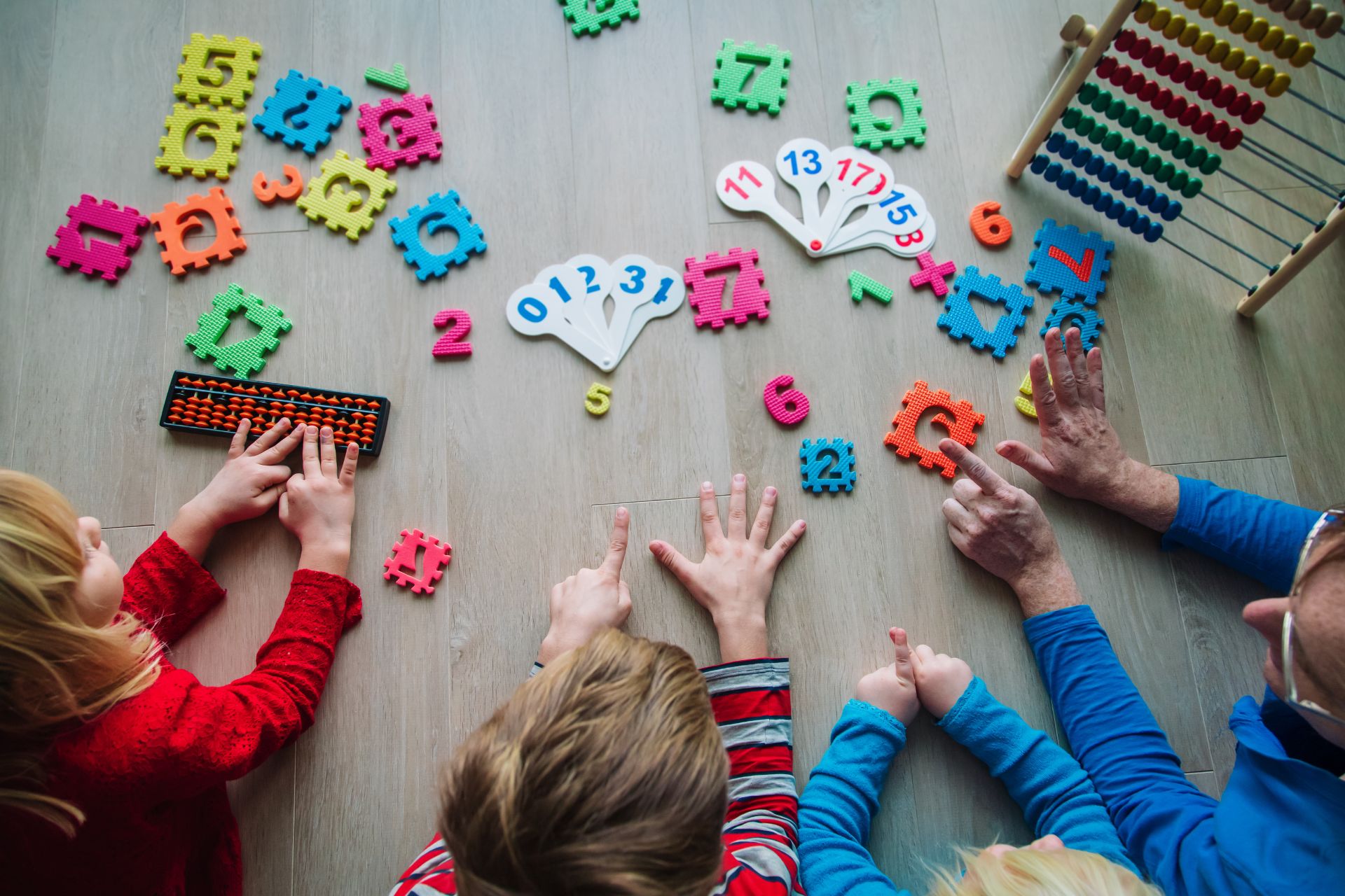 Children learning to count with fingers, blocks and other toys