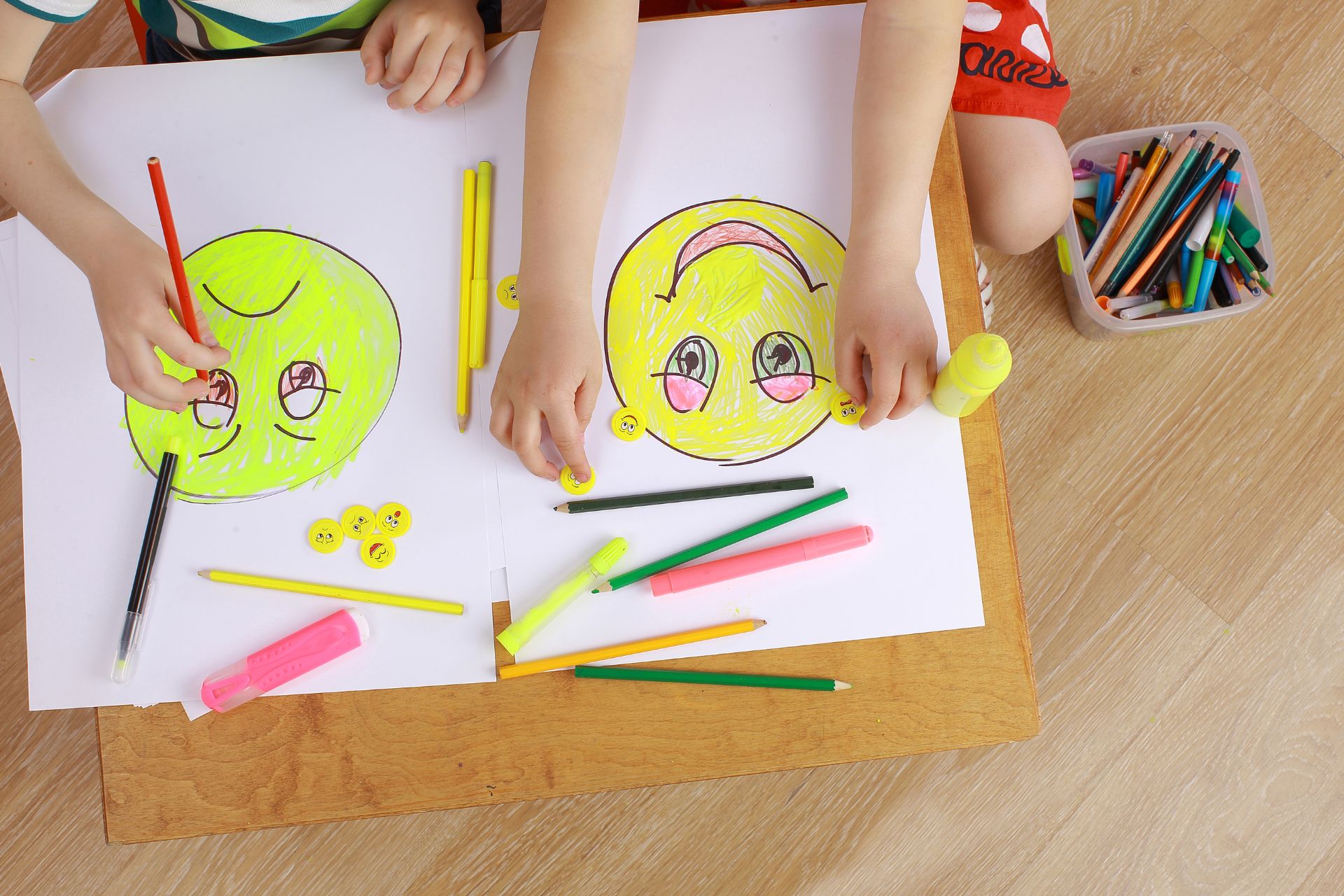 Children coloring happy and sad face